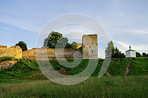 A view of the medieval Izborsk fortress walls and towers in suns