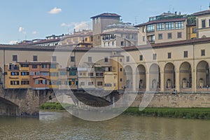 View of medieval stone bridge Ponte Vecchio and the Arno River from the Ponte Santa Trinita Holy Trinity Bridge in Florence,