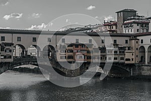 View of medieval stone bridge Ponte Vecchio and the Arno River from the Ponte Santa Trinita Holy Trinity Bridge in Florence,