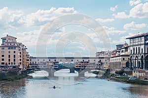 View of medieval stone bridge Ponte Vecchio and the Arno River from the Ponte Santa Trinita Holy Trinity Bridge in Florence,