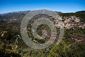 View of the medieval village of Siurana with the serpentine road, mountains in Tarragona, Spain