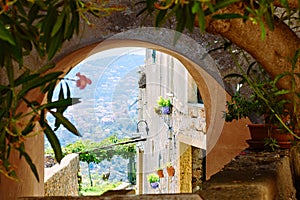 View of a Mediterranean bay from a stone arch of a medieval village in the Ligurian Riviera, Borgio Verezzi, Liguria, Italy
