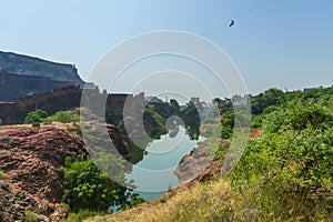 View of Mehrangarh fort from Rao Jodha desert rock park, Jodhpur, India. Desert rocks in foreground and Mehrangarh fort in the