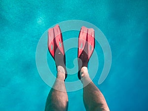 view of men legs in flippers under water