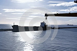 View on the merchant ship moored along concrete breakwater from Algeciras, Spain, container terminal.