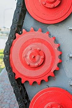 View of the metal chain with cogwheel of the mechanical unit of an old railway repair train