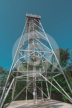 View of metal observation tower in white color just above the town of Rogaska Slatina on a sunny day