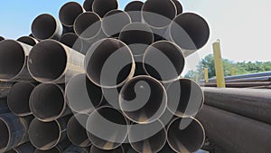 View through metal pipes of large diameter. Metal pipes of large diameter in a metal warehouse, large pipes in an open