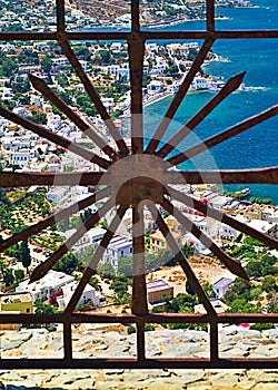 View through a metal railing on a window to Leros island, Dodecanese, Greece