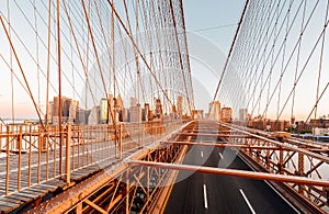 View from the metallic structure of Brooklyn Bridge in New York City at sunrise