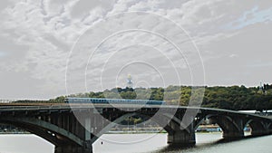 View of the metro bridge in Kiev, Ukraine. Lively traffic, summer time, slow motion shot.