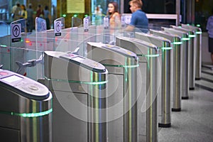 View on metro station ticket barriers with green light for entry. Moscow metro station. Station entrance tourniquet green light to photo