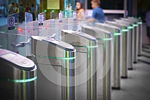 View on metro station ticket barriers with green light for entry. Moscow metro station. Station entrance tourniquet green light