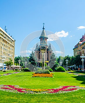View of the metropolitan cathedral in romanian city timisoara with a statue of romulus, remus and a wolf in front of it