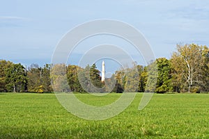 View of Minaret in Lednice between trees under autumn sky