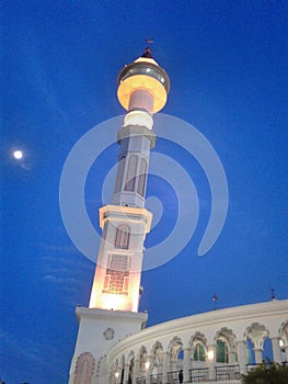 View of minaret the mosque at dusk before evening. The more beautiful because it seems the moon