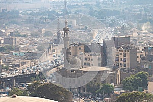 View of misty of city of Cairo in Egypt, due to traffic pollution, over rooftop slums and mosques