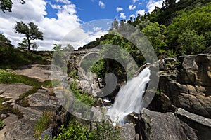 View of the Mizarela Bridge with a waterfall at the Peneda Geres National Park photo