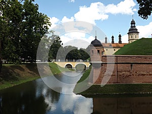 View of the moat and the corner tower of the Radziwill Palace in Nesvizh