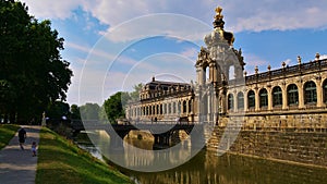 View of moat and outside facade of popular historic palatial building complex Zwinger built in the 18th century.