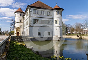 View of moated castle of Bad Rappenau at the beginning of spring with reflections in the castle moat