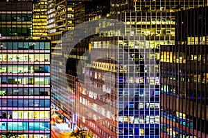 View of modern architecture along 51st Street at night, in Manhattan, New York.