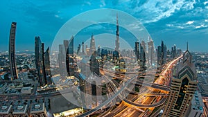 View on modern skyscrapers and busy evening highways day to night timelapse in luxury Dubai city, Dubai, United Arab