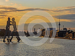 View on the Molecular men with TV tower at sunset in Berlin, Germany