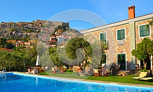 View of Molyvos Village and Castle with hotel pool in foreground. Lesbos Greece.
