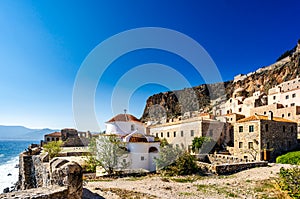 View on Monemvasia street panorama with old houses and Panagia Chrysafitissa church in ancient town, Peloponnese, Greece
