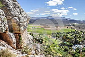 View of Montagu Springs valley and Mountain range with large red rocky outcrops and lush green vegetation, Montagu Springs