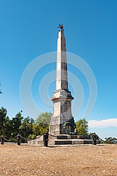 View of monument commemorating war soldiers, mountains on background, in Bucaco, Portugal. photo