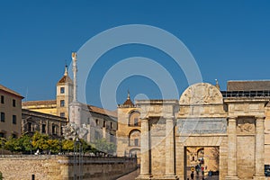 View of the monument Puerta del Puente, Cordoba, Andalusia, Spain. Isolated on blue background
