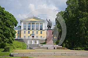 View of the monument to Lenin on a background of an urban high school in Zelenogorsk