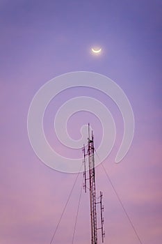 View of the moon on the dusk sky and the folded dipole radio ant