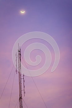 View of the moon on the dusk sky and the folded dipole radio ant