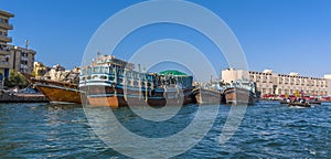 A view of moored dhow cargo vessels and Abra water taxis on the Dubai Creek in the UAE