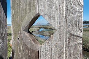 View of Morro Rock through the fence