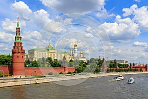 View of Moskva river with floating pleasure boats near Moscow Kremlin in sunny summer day