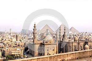 View on the Mosque-Madrassa of Sultan Hassan in Cairo and the Pyramids of Giza, Egypt