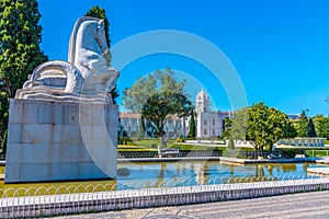 View of mosteiro dos Jeronimos through praca do imperio in Belem, Lisbon, Portugal photo