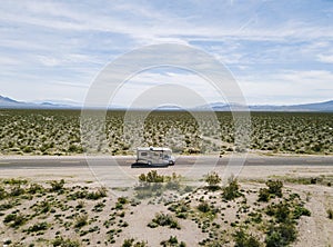 View of a motorhome driving on a highway in the desert of USA California