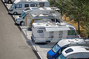 View of motorhomes parked on the side of the road in foreign tourists campsite