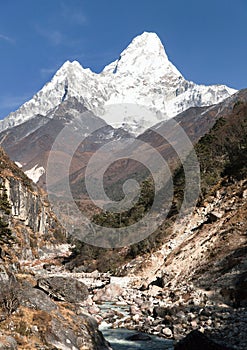 View of mount Ama Dablam with stony and wooden bridge