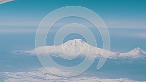 View of Mount Ararat from an airplane. Snow-capped mountain top. Biblical mount Ararat taken from the Airplane