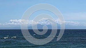 View of Mount Batur in Bali through the strait from the island of Lombok, Indonesia