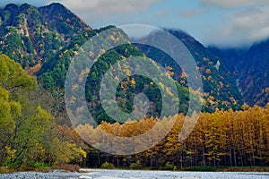 Kamikochi National Park in the Northern Japan Alps of Nagano Prefecture, Japan. Beautiful mountain in autumn leaf and Azusa river