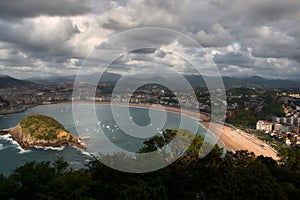 View from Mount Igueldo of Concha Beach and the Santa Clara Island on a stormy day photo