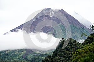 View of Mount Merapi in the morning, and slightly covered by clouds. Potentially eruptive volcano