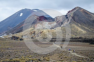 View of Mount Ngauruhoe - Mount Doom from Tongariro Alpine Crossing hike with clouds above and red crater in foreground